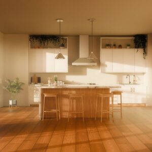 Interior of domestic kitchen with island and white cabinets in bright daylight