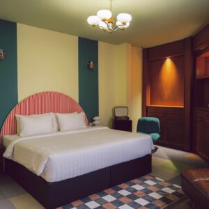 Retro Boutique Hotel Bedroom with Double Bed, Accent Wall, and Vintage Decor