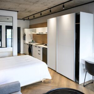 Open plan luxury hotel apartment with a sleek modern design, clean lines and coordinated finishes